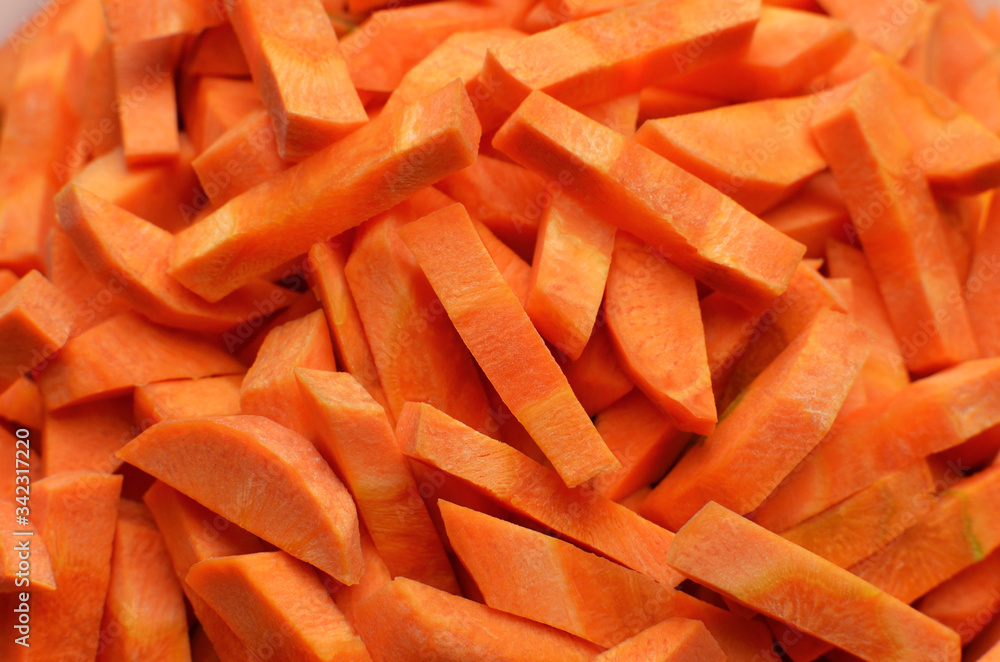 Chopped carrot full frame closeup. Vegan food background. Carrot sticks. Food preparation. Chopped carrot full frame closeup. Vegan food background. Carrot sticks. Food preparation.