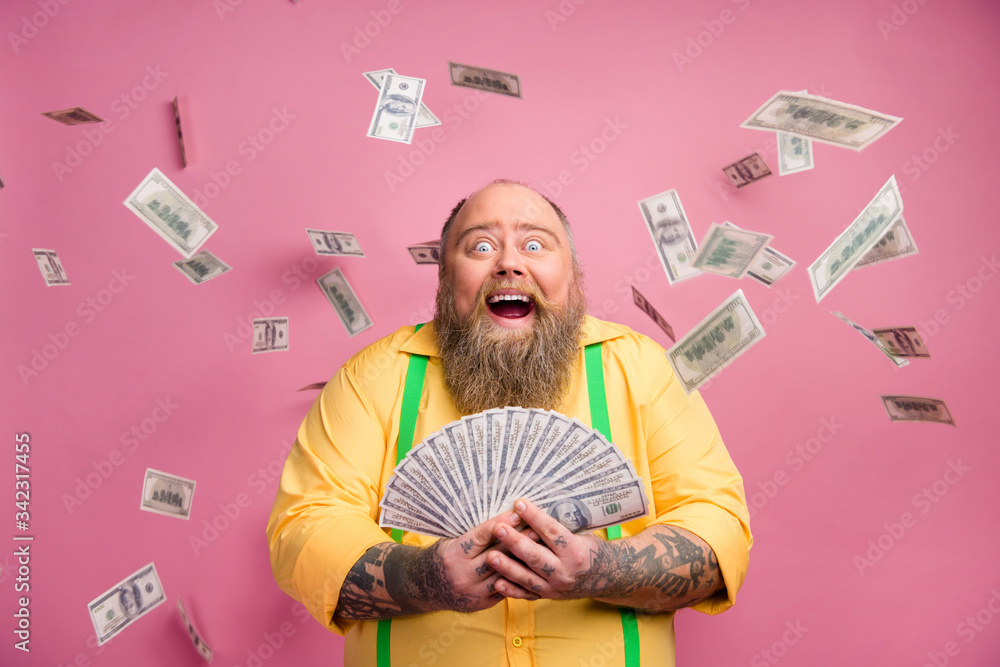 Close-up portrait of his he nice cheerful cheery wealthy bearded guy holding in hands bunch income subsidy donation usd for new life isolated over pink pastel color background - obrazy, fototapety, plakaty 