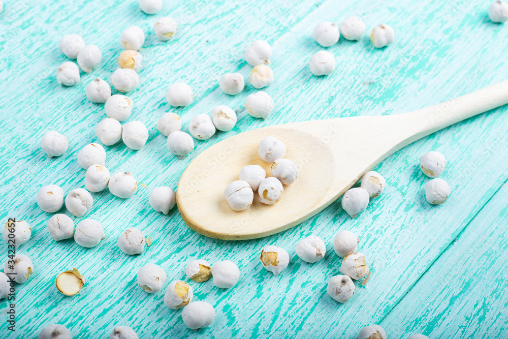 dry chickpeas in a spoon on the table dry chickpeas in a spoon on the table