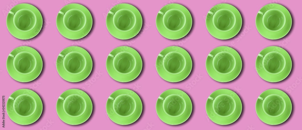Bright colorful pattern. A green cups on a pink background Bright colorful pattern. A green cups on a pink background
