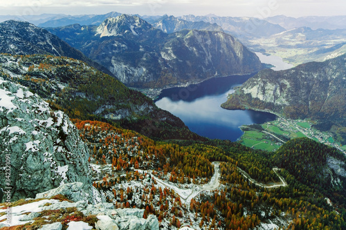 Fototapeta Naklejka Na Ścianę i Meble -  View from above to Hallstatter lake and Hallstatt village among Alps mountains in Austria. Beautiful nature landscape. Autumn season and trees with orange colour. Wonderful valley of rocks and ridges.