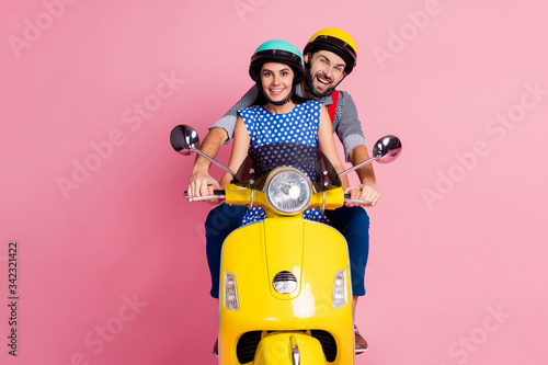 Fototapeta Naklejka Na Ścianę i Meble -  Portrait of his he her she nice attractive cheerful cheery couple driving moped spending time vacation holiday weekend isolated over pink pastel color background