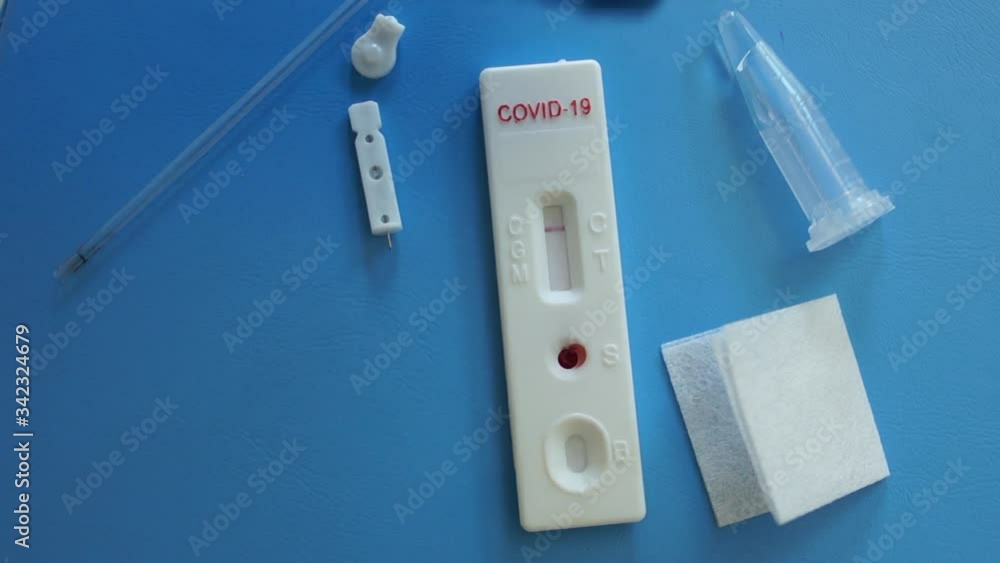 Rapid test covid 19. Doctors hand in a protective glove puts a test cassette on the table with a negative result SARS-CoV-2 Rapid test covid 19. Doctors hand in a protective glove puts a test cassette on the table with a negative result SARS-CoV-2