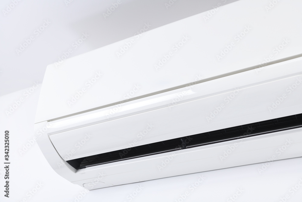 Air conditioner system on white wall room. Air conditioning.A white air conditioner is installed on a white wall in the apartment.
Air conditioner system on white wall room. Air conditioning.A white air conditioner is installed on a white wall in the apartment.