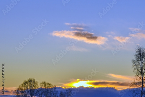 Landscape-cold sunset behind the treetops