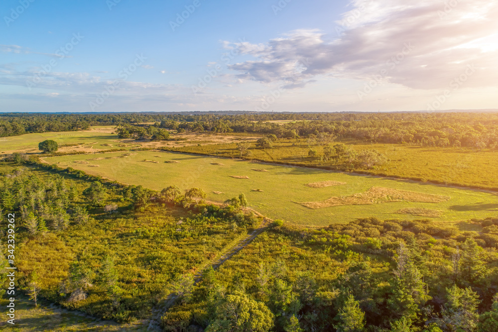 Sun shining on farmland in Australia - aerial view