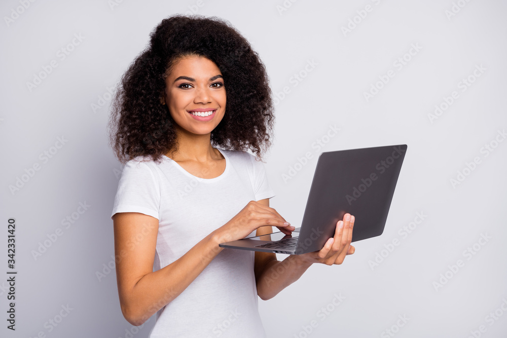 Profile side view portrait of her she nice attractive lovely confident cheerful cheery wavy-haired girl holding in hands laptop working part-time isolated over light white pastel color background Profile side view portrait of her she nice attractive lovely confident cheerful cheery wavy-haired girl holding in hands laptop working part-time isolated over light white pastel color background