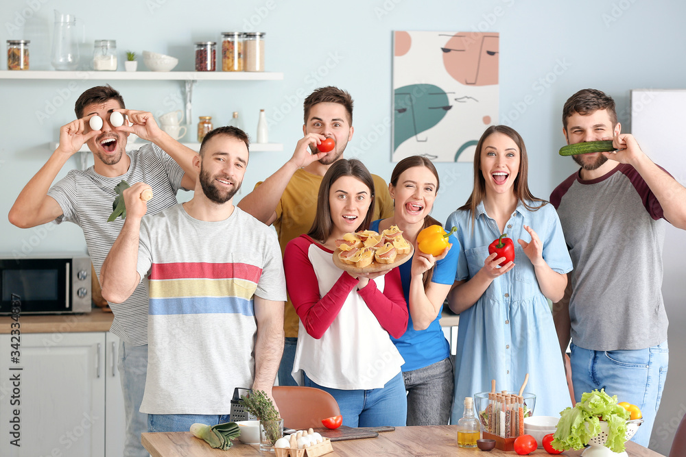Young friends having fun while cooking together at home Young friends having fun while cooking together at home