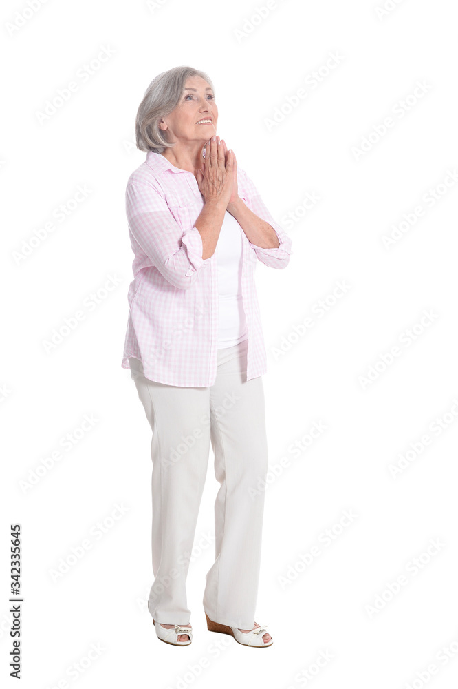 Portrait of senior woman praying on white background Portrait of senior woman praying on white background