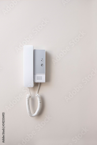 White intercom on a wall