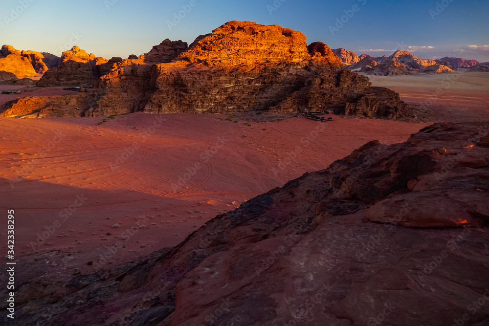 WADI RUM DESERT, JORDAN - FEBRUARY 06, 2020: Sunset over the massif of Jebel Khash and strange red rocks