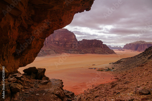 WADI RUM DESERT, JORDAN - FEBRUARY 08, 2020: View towards Rum village from the rocks of Jebel Ishrin photo