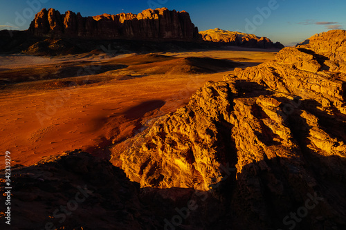 WADI RUM DESERT, JORDAN - FEBRUARY 06, 2020: Sunset over the massif of Jebel al Qatar and strange red rocks