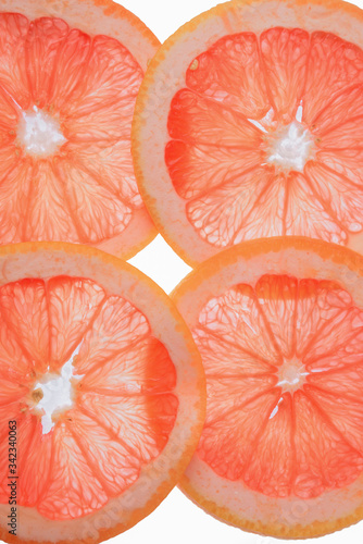 translucent grapefruit slices on a white background, citrus fruit slices