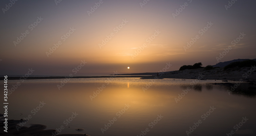 landscape of a sunset in the sea, the sky and the sea are tinged with orange colors