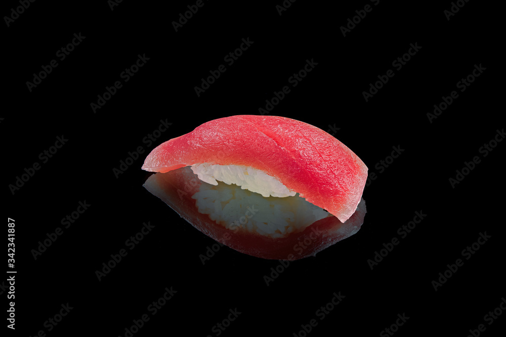 Classic japanese sushi with tuna on a black background with reflection. Photo for the menu Classic japanese sushi with tuna on a black background with reflection. Photo for the menu