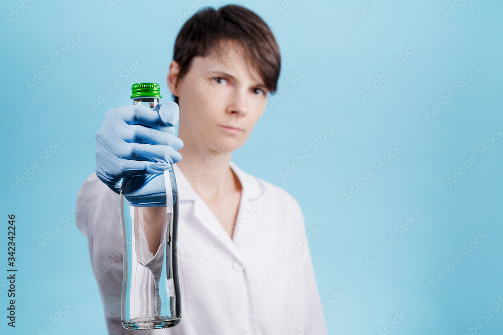 portrait of a beautiful woman doctor who holds a bottle of clean drinking water as a healthy food concept portrait of a beautiful woman doctor who holds a bottle of clean drinking water as a healthy food concept