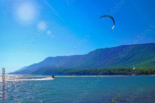 Akyaka, Mugla/Turkey-August 14 2018: Surfer enjoying kite surfing at the beach where Azmak River meets the Mediterranean Sea