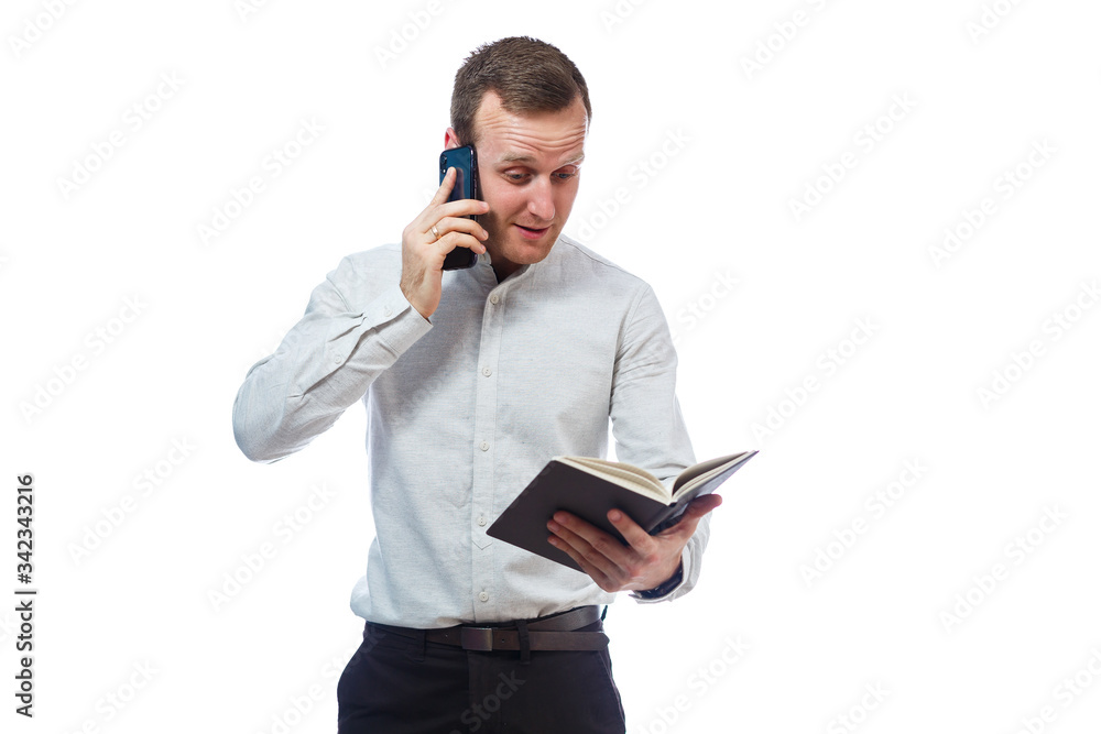 man businessman, teacher, mentor examines entries in your diary and talking on a cell phone. Isolated on white background man businessman, teacher, mentor examines entries in your diary and talking on a cell phone. Isolated on white background