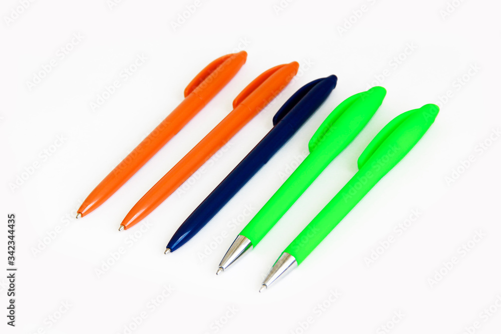 multi-colored stationery plastic writing pens on a white background multi-colored stationery plastic writing pens on a white background