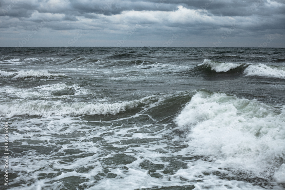 Dark clouds and the crash of sea waves during a storm in the Black Sea in Odessa.Art photo 
