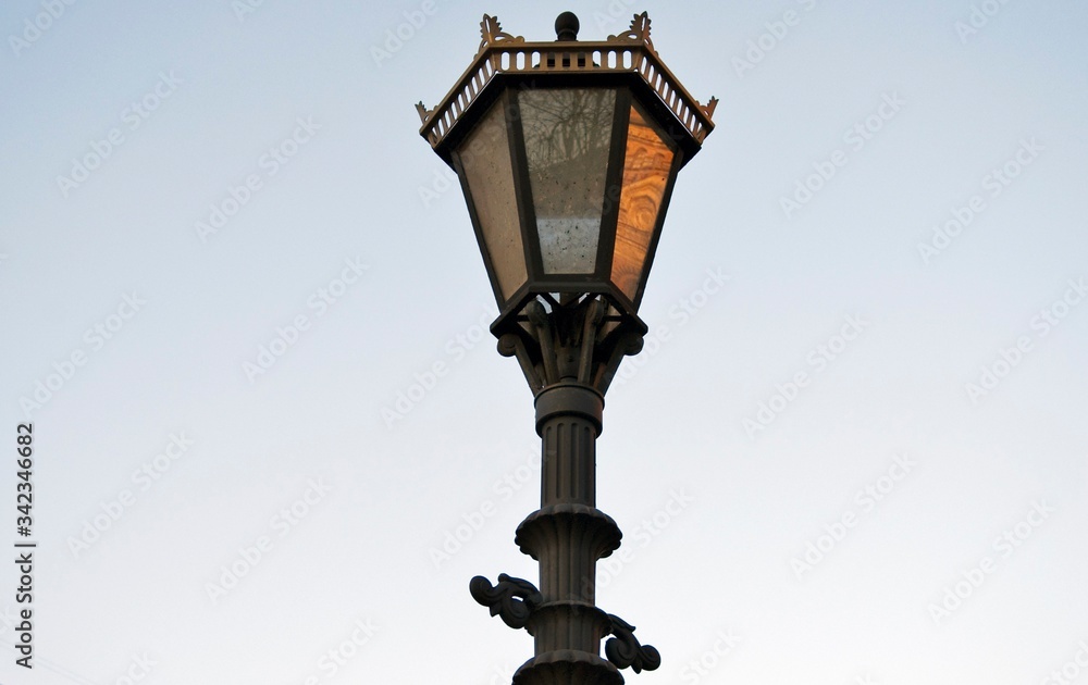 Old street lamp on blue sky. Color photo taken at Saint-Petersburg, Russia.