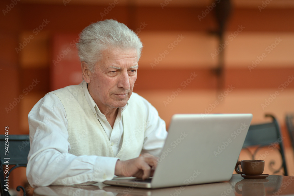 Portrait of a senior man using laptop Portrait of a senior man using laptop