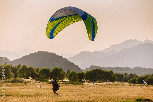 A man on a paraglider prepares to fly