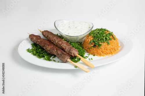 Horizontal picture of Beef Kufta, also known as; Shish Tawook/Tawouk, served with brown rice with yogurt salad put on white background.  photo