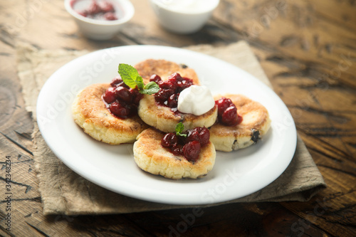 Homemade cottage cheese cakes with cherry sauce