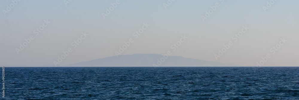 Fototapeta premium Lonely volcanic island far above the water.