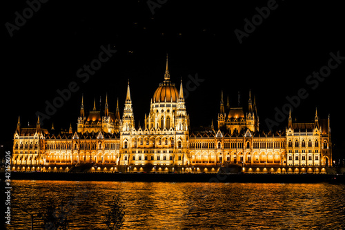 Hungarian Parliament building and Danube River in the Budapest city at night. A sample of neogothic architecture, Budapest's tourist attraction