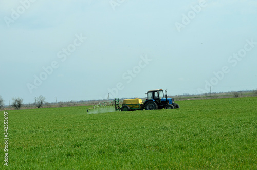 Tractor waters plants on the field ,Ukraine,agriculture