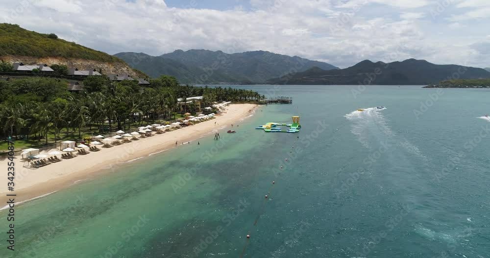 Aerial view of Hon Tam island, Nha Trang Bay, Khanh Hoa, Vietnam. Hon Tam has all potentials of a class resort with deep blue sea harmonized with the golden sand and green tropical forest Aerial view of Hon Tam island, Nha Trang Bay, Khanh Hoa, Vietnam. Hon Tam has all potentials of a class resort with deep blue sea harmonized with the golden sand and green tropical forest
