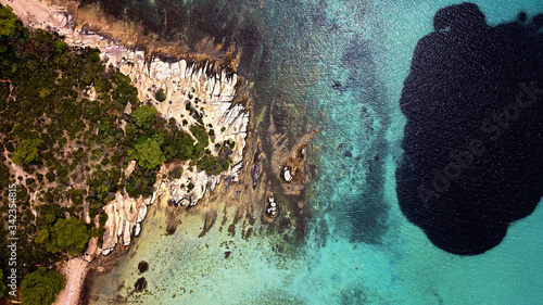 Top down aerial view of beautiful exotic beach terrain with a black spot