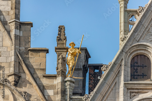 Gilded statue on top of Guildhouses view from Grand Market Square in Antwerp, Belgium photo