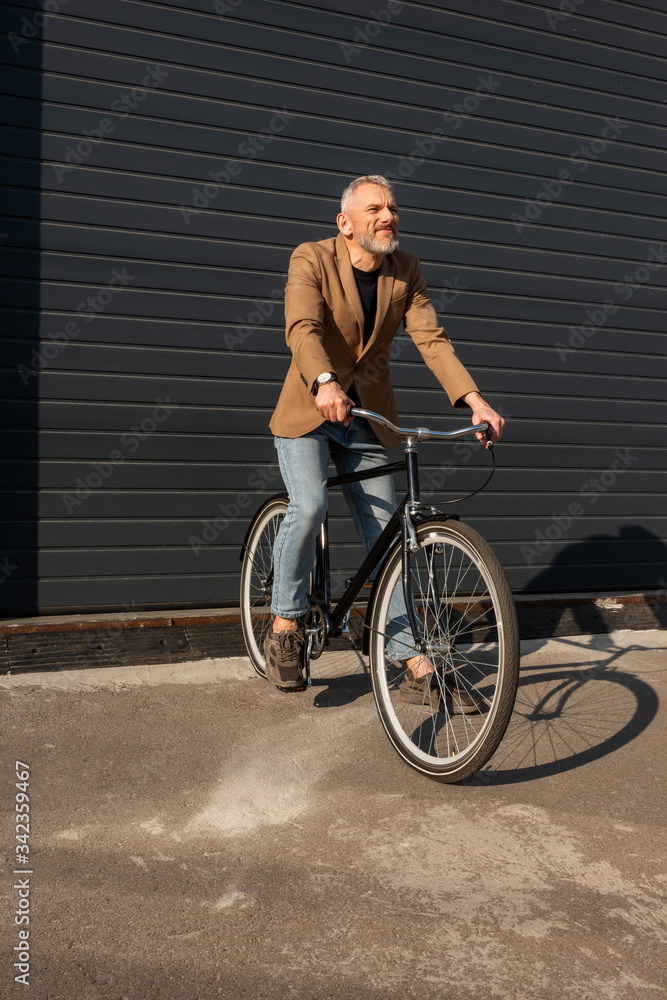 sunlight on handsome businessman riding bicycle outside sunlight on handsome businessman riding bicycle outside