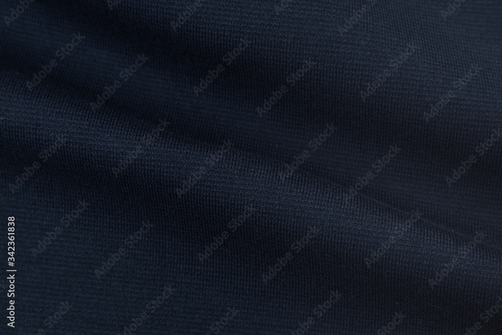 Blue dark monochrome cotton fabric. Closeup texture of the fabric is useful as a background. Blue dark monochrome cotton fabric. Closeup texture of the fabric is useful as a background.
