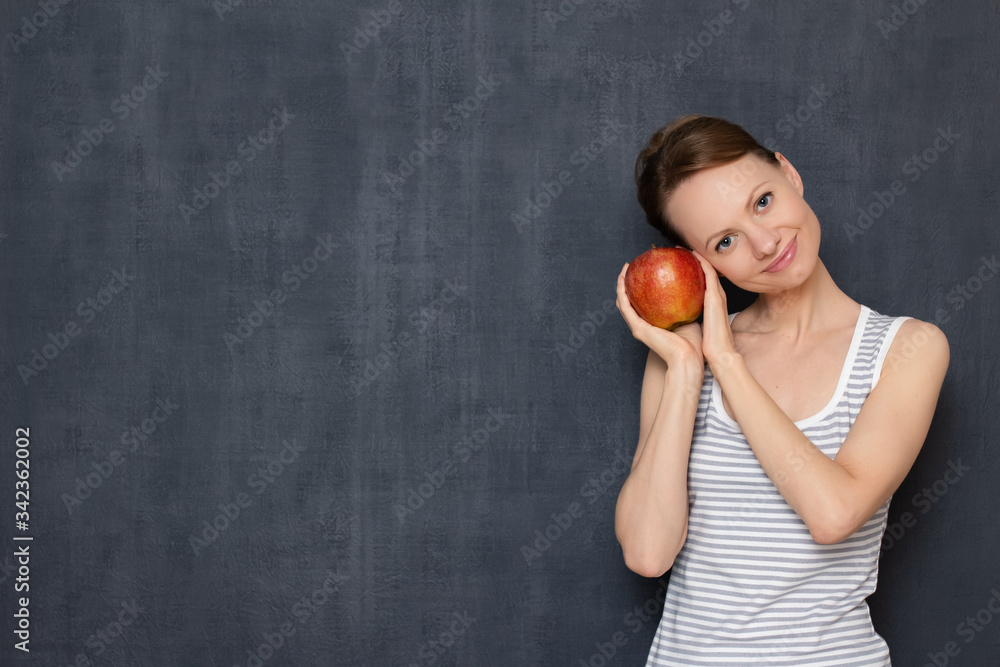 Portrait of happy girl holding ripe apple in hands and smiling Portrait of happy girl holding ripe apple in hands and smiling