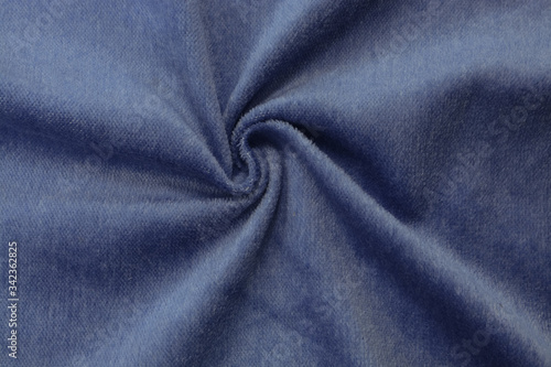 Corduroy blue background in close up. Texture of soft corduroy textile - useful as background