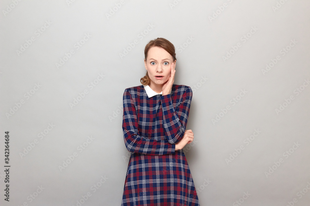 Portrait of sad shocked young woman with widened eyes and open mouth Portrait of sad shocked young woman with widened eyes and open mouth