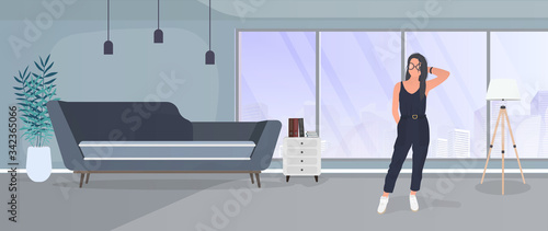 Brunette girl posing. Model in a stylish suit. Room, sofa, floor lamp, paintings on the wall, bookcase with books, a girl with black hair. Vector.