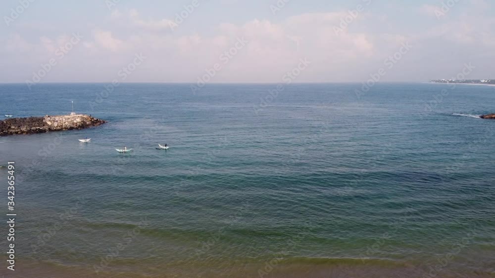 Traditional Sri Lanka fishing boats on the beach. Aerial drone footage