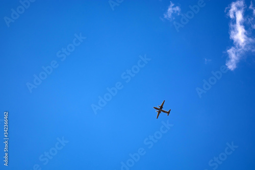 dark silhouette of airplane flying over the blue skies