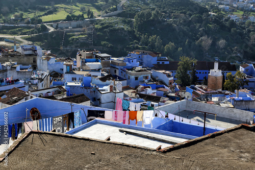 Chefchaouen, Morocco - 02.24.2019: View from the ramparts on the roofs of buildings where locals dry clothes. © Nadzeya