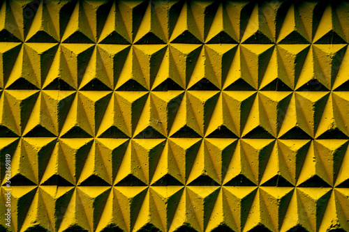 Yellow geometric repeating shapes with shadow. Background from yellow geometric shapes. Yellow 3D Mosaic