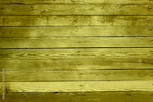The texture of a wooden flight painted in yellow. Textrua gently yellow wooden surface. Yellow wooden background.