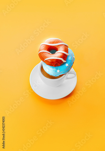donuts with coffee on a yellow background photo