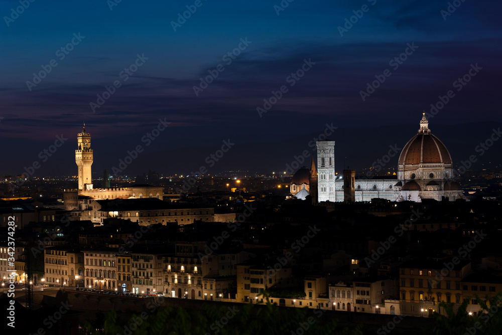 Florence at dusk - Panorama of Florence, Tuscany, Italy after sunset with the city center and landmarks: Lungarno, cathedral and Palazzo Vecchio (medieval city hall) illuminated under the evening sky
