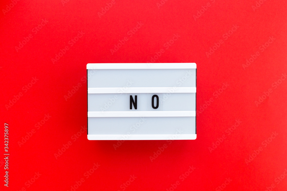 Message No on white lightbox isolated on red background. Concept of daring to say no with confidence Message No on white lightbox isolated on red background. Concept of daring to say no with confidence